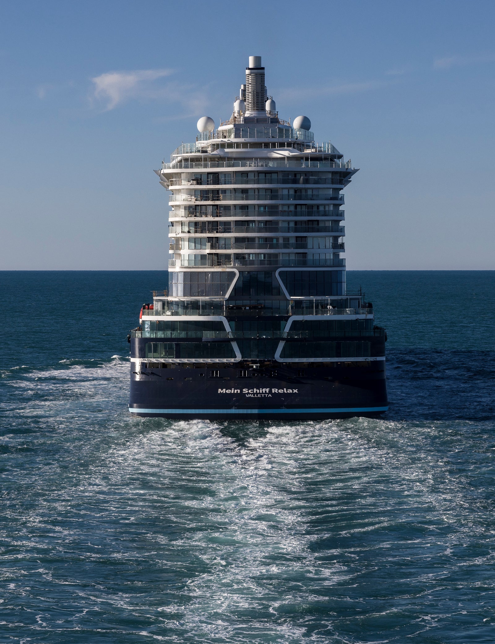 Fincantieri | About Us - Global Presence: Modern operational cruise ship sailing on the open ocean, visible wake, multiple decks and refined design, “Wonder of the Seas” written on the hull, clear day with calm water and blue sky.