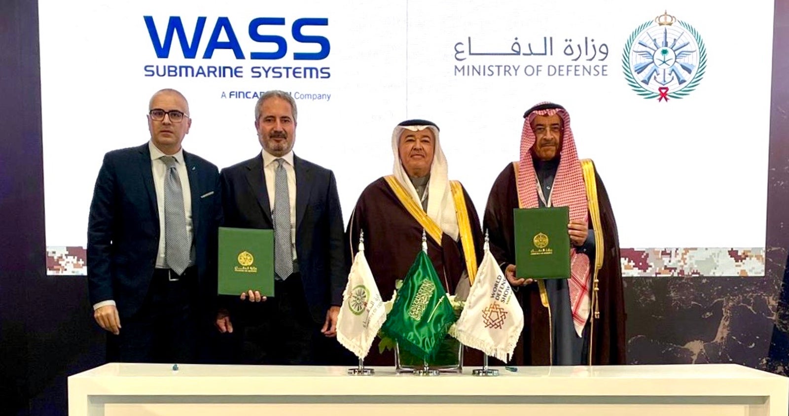  Newsroom - Press releases - 2026 - Fincantieri Group: fincantieri group: wass secures contract to supply torpedoes to the royal saudi naval force: executives from wass and saudi ministry of defense in formal attire hold agreement at signing ceremony with flags.