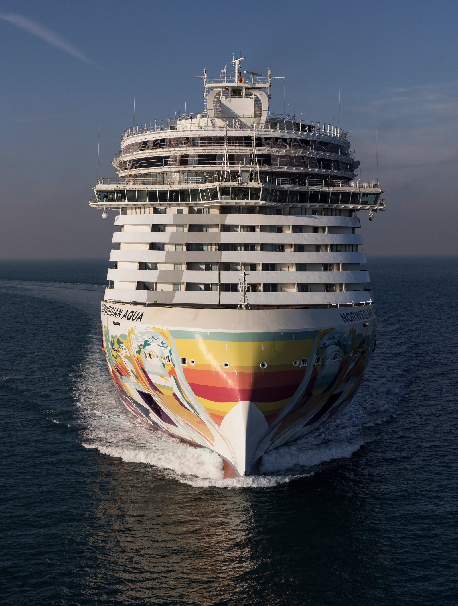 Fincantieri | Gruppo - Business - Prodotti - Navi da Crociera - Norwegian Aqua: Bow of cruise ship Norwegian Aqua in open sea, multicolored rainbow livery.