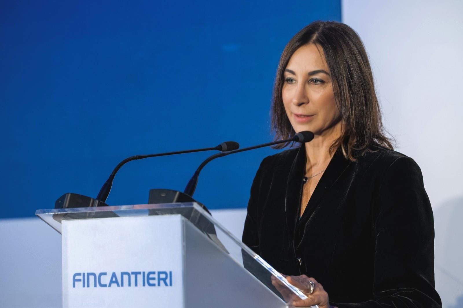 newsroom - press releases - 2025 - fincantieri group: fincantieri launches "captain", the ai agent revolutionizing the group's digital communication: speaker wearing a dark suit at the fincantieri lectern, double microphone, blue and white background.