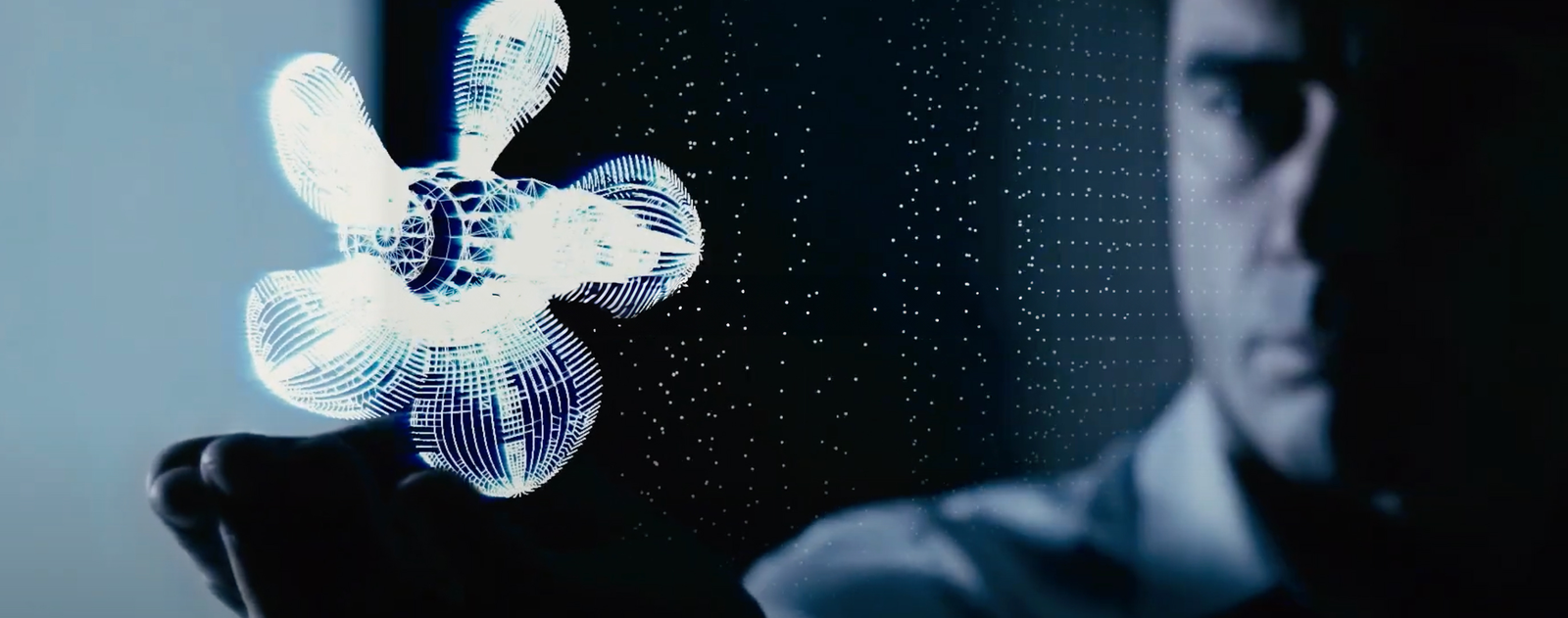 Fincantieri | About Us - Future on Board: Luminous holographic propeller on a dark background, with light patterns and grid points, design highlighting precision, advanced technology, and concepts of modern engineering in a digital or virtual environment.