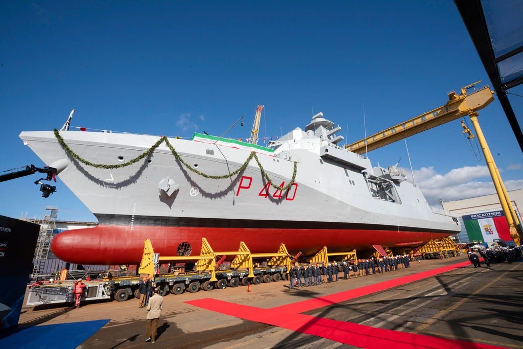 Newsroom - Press releases - 2026 - Fincantieri Group: launch of the first next-generation offshore patrol vessel for the Italian Navy: italian navy next-generation offshore patrol vessel in the water at shipyard, bow view under blue sky.