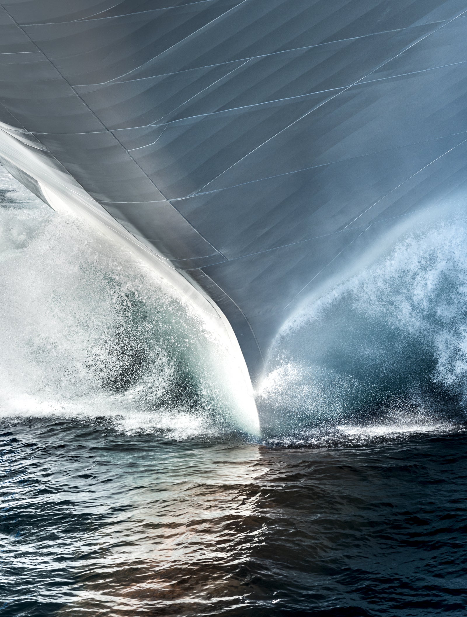 Fincantieri | Group - Business - Products - Cruise Ships - Silver Muse: Bow view of Silver Muse cruise ship in operation, sleek design cutting through water with spray and foam.