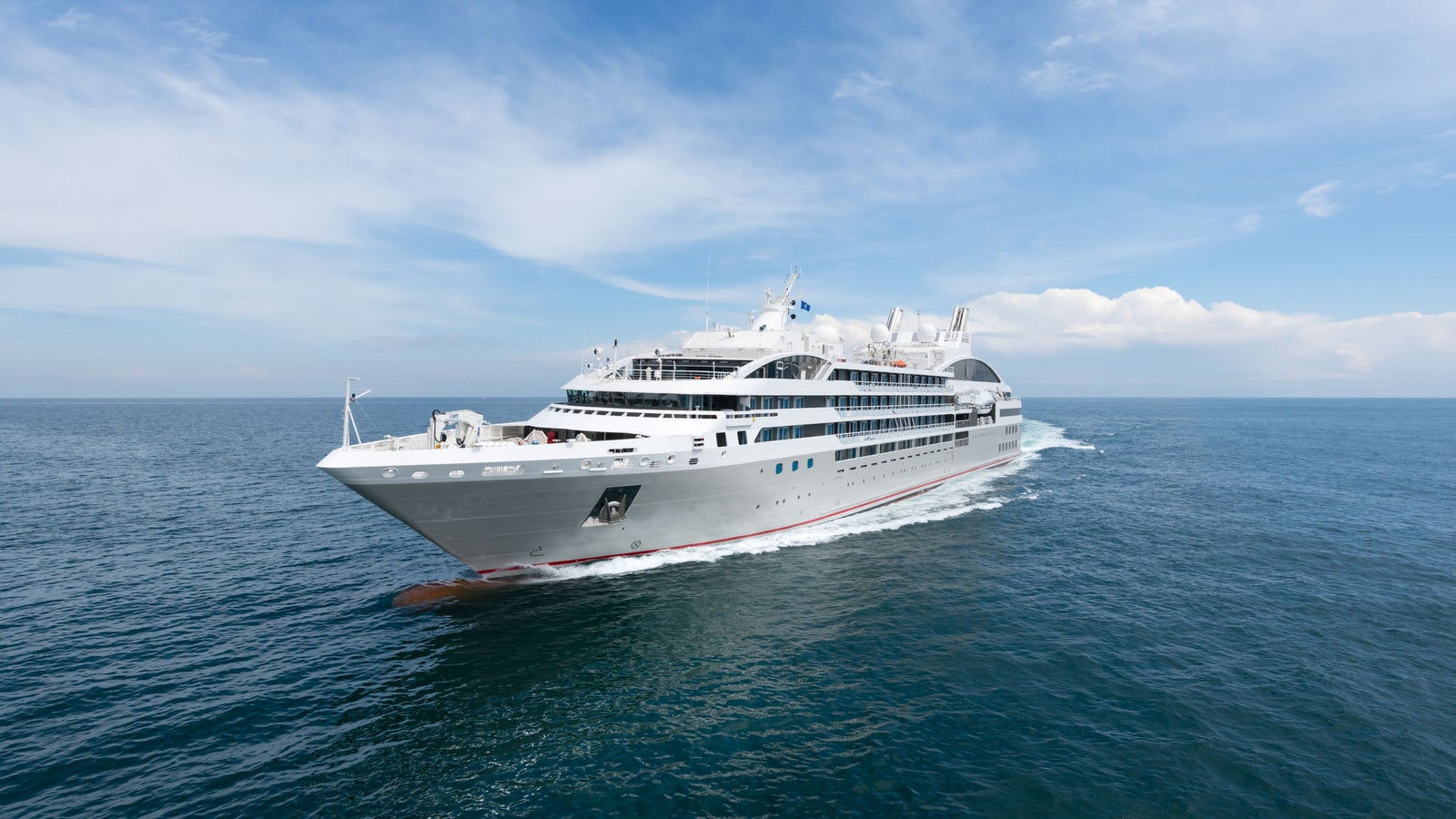 Fincantieri | Group - Business - Products - Cruise Ships - Le Soléal: Side view of Le Soléal cruise ship in operation navigating open sea, linear white hull, multiple passenger decks, visible lifeboats along sides.