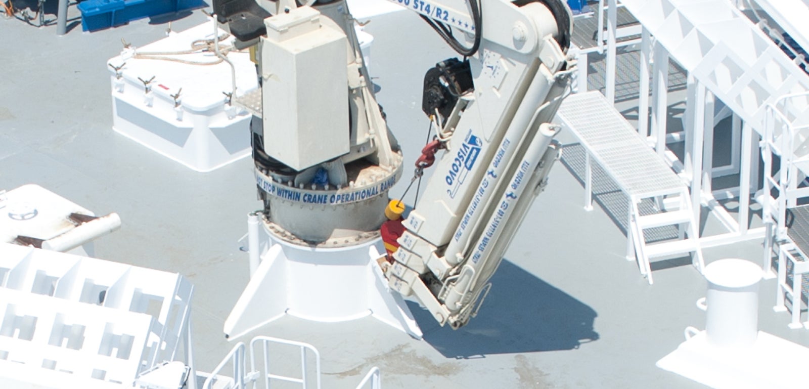  Fincantieri | Group - Business - Products - Cruise Ships - L'Austral: Large white cruise ship in operation crossing deep blue ocean waters, streamlined exterior, advanced deck machinery and navigation instruments visible, calm surroundings create peaceful atmosphere, technical features highlight operational capabilities.