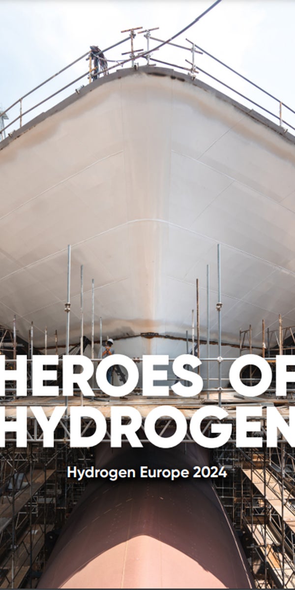 Fincantieri | Group - Innovation - Naval Ecosystem of the Future - Wave 2 the Future: Large ship under construction with scaffolding around the hull, texts ‘Heroes of Hydrogen’ and ‘Hydrogen Europe 2024’ clearly visible, focus on industrial innovation and sustainable energy.