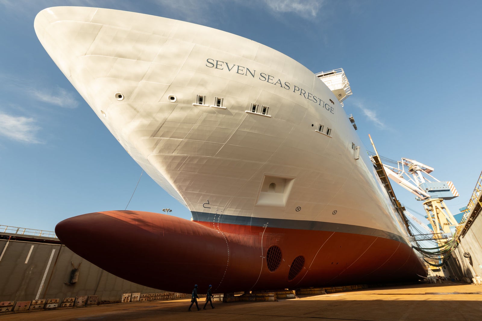 newsroom - press releases - 2025 - fincantieri group: fincantieri seven seas prestige launched in marghera: bow view of the "seven seas prestige" cruise ship on the slipway before launch, red hull and white superstructure, blue sky.