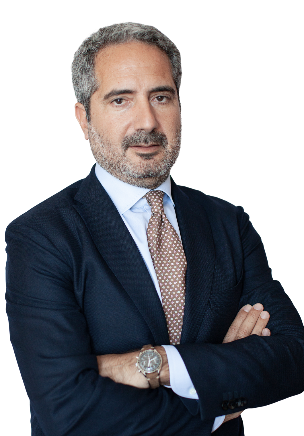 Fincantieri - Investing in Fincantieri: Manager Folgiero in dark blue suit, white shirt, and patterned tie, standing with arms crossed, silver watch visible on wrist, minimal white background.