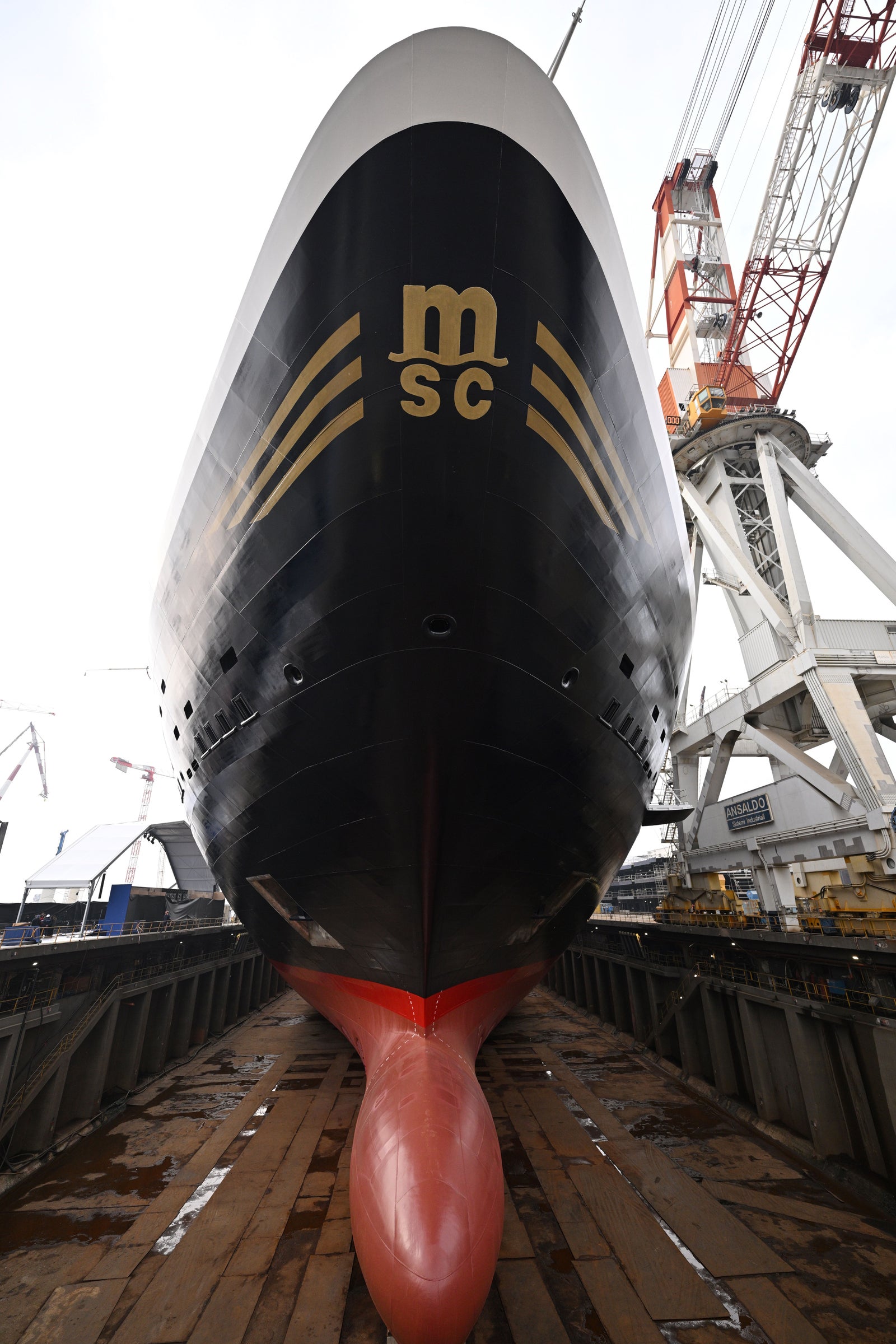 Newsroom - Press releases - 2026 - Fincantieri Group: Fincantieri:  Today triple ceremony for Fincantieri and Explora Journeys at Sestri Ponente: launche of Explora IV, coin ceremony for Explora V and steel cuttingfor Explora VI: Bow of Explora IV cruise ship with MSC logo in dry dock at Sestri Ponente, with cranes and shipyard visible.