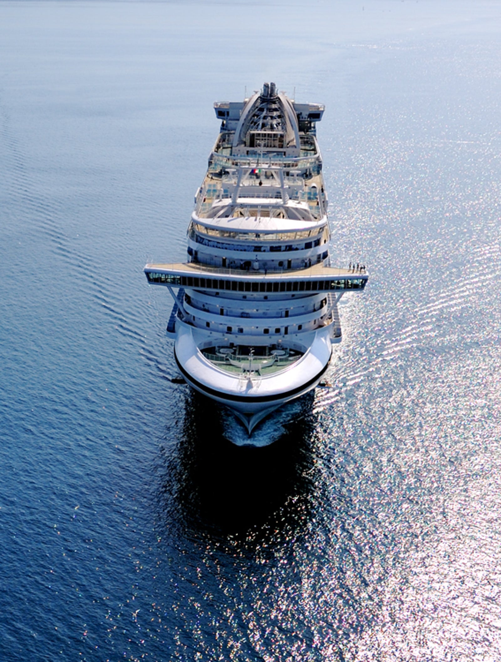 Fincantieri | Gruppo - Business - Prodotti - Navi da Crociera - Ruby Princess: Grande nave da crociera di lusso operativa che naviga su acque calme e aperte sotto cielo sereno, vista aerea che evidenzia maestosità della nave e immensità dell’oceano circostante.