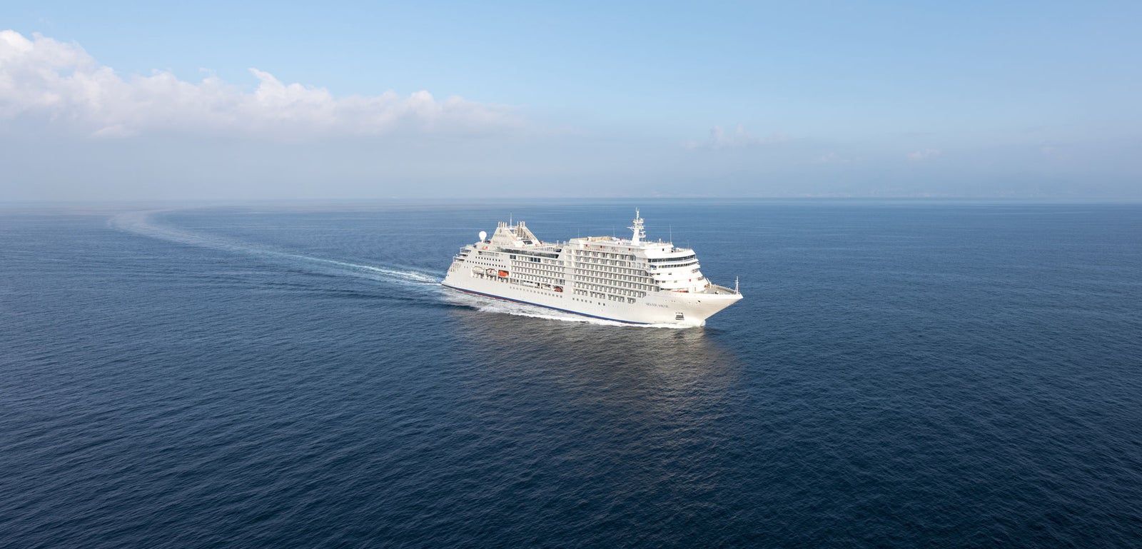 Fincantieri | Group - Business - Products - Cruise Ships - Silver Muse: Front view of Silver Muse cruise ship in operation, white hull with multiple passenger decks and visible windows.