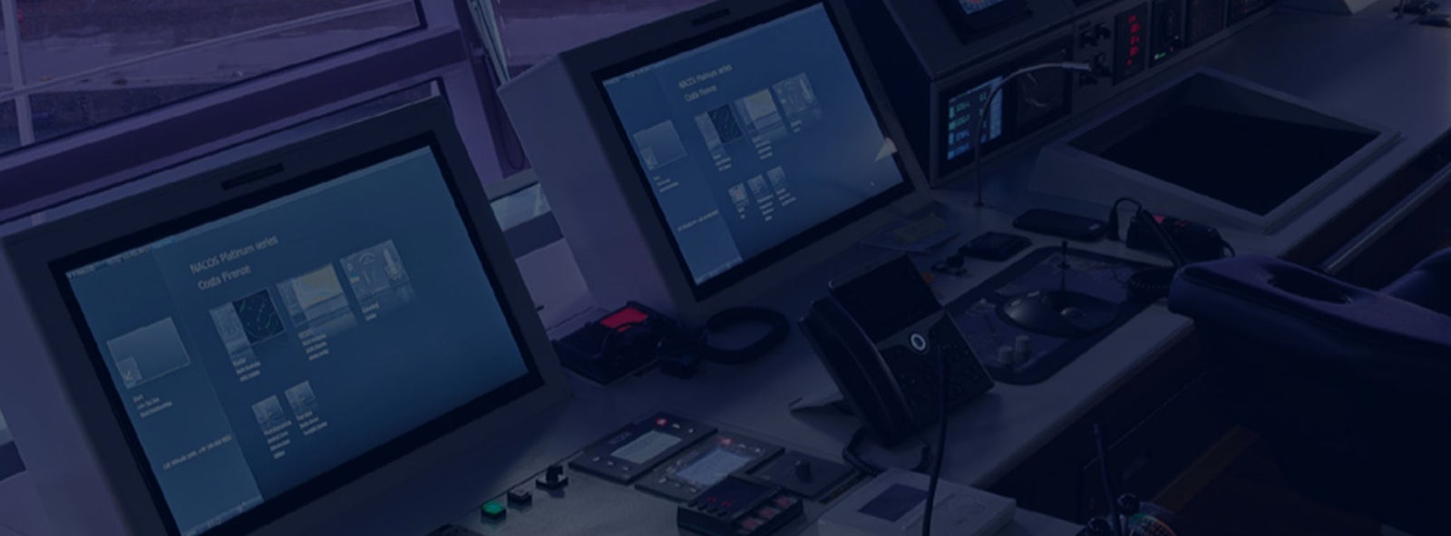 Fincantieri | Group - Sustainability - Energy Transition: Control room with multiple monitors and electronic equipment, screens displaying data and interfaces, complex operational environment.