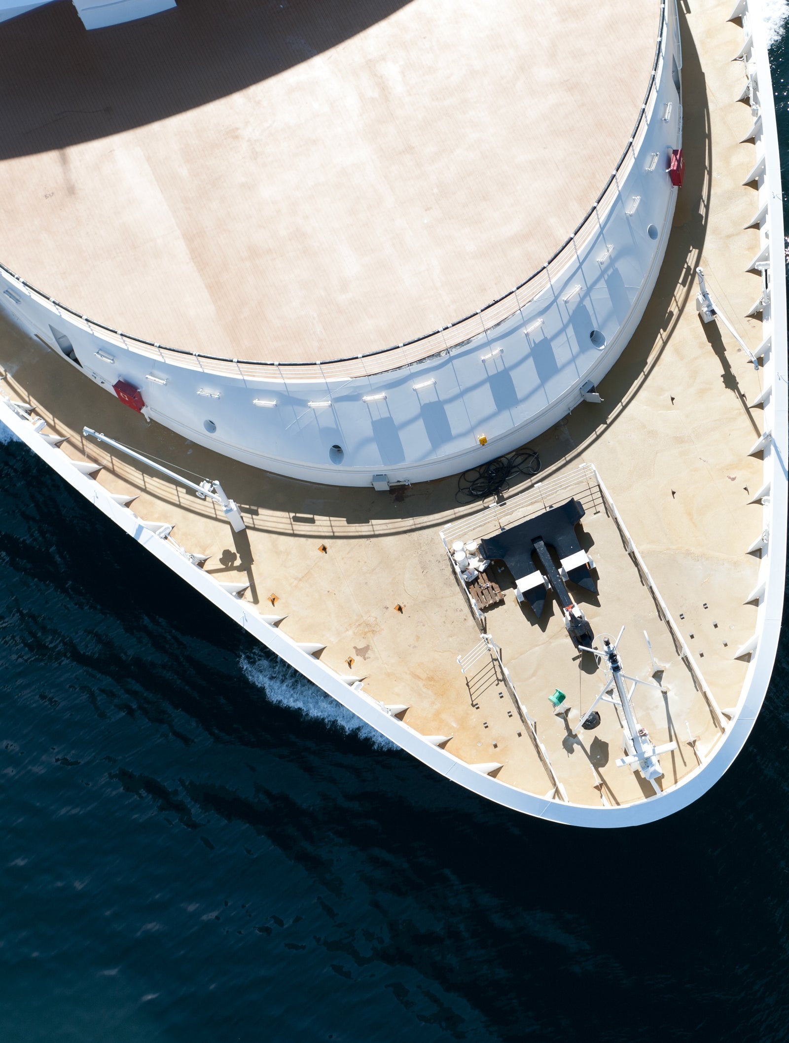  Fincantieri | Group - Business - Products - Cruise Ships - Nieuw Amsterdam: Aerial view of large luxury cruise ship in operation navigating calm open waters, multiple decks with seating areas and visible equipment, serene ocean environment emphasizing leisure and travel, no visible text or numeric values.
