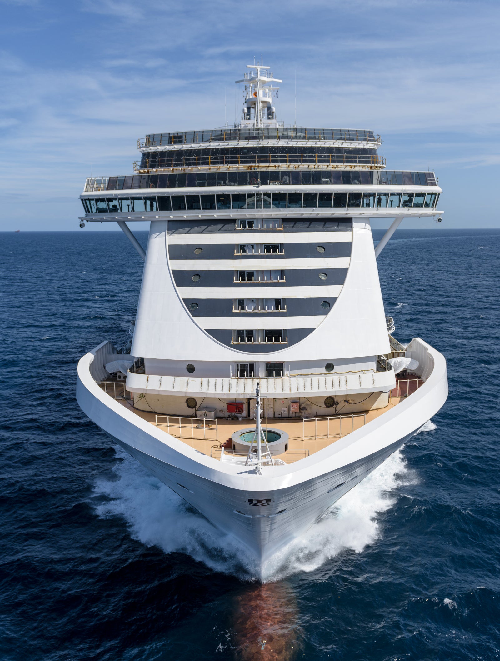 Fincantieri | Group - Business - Products - Cruise Ships - MSC Seaside: Front view of MSC Seaside cruise ship in operation, white hull with multi-level passenger decks, bow cutting through waves.