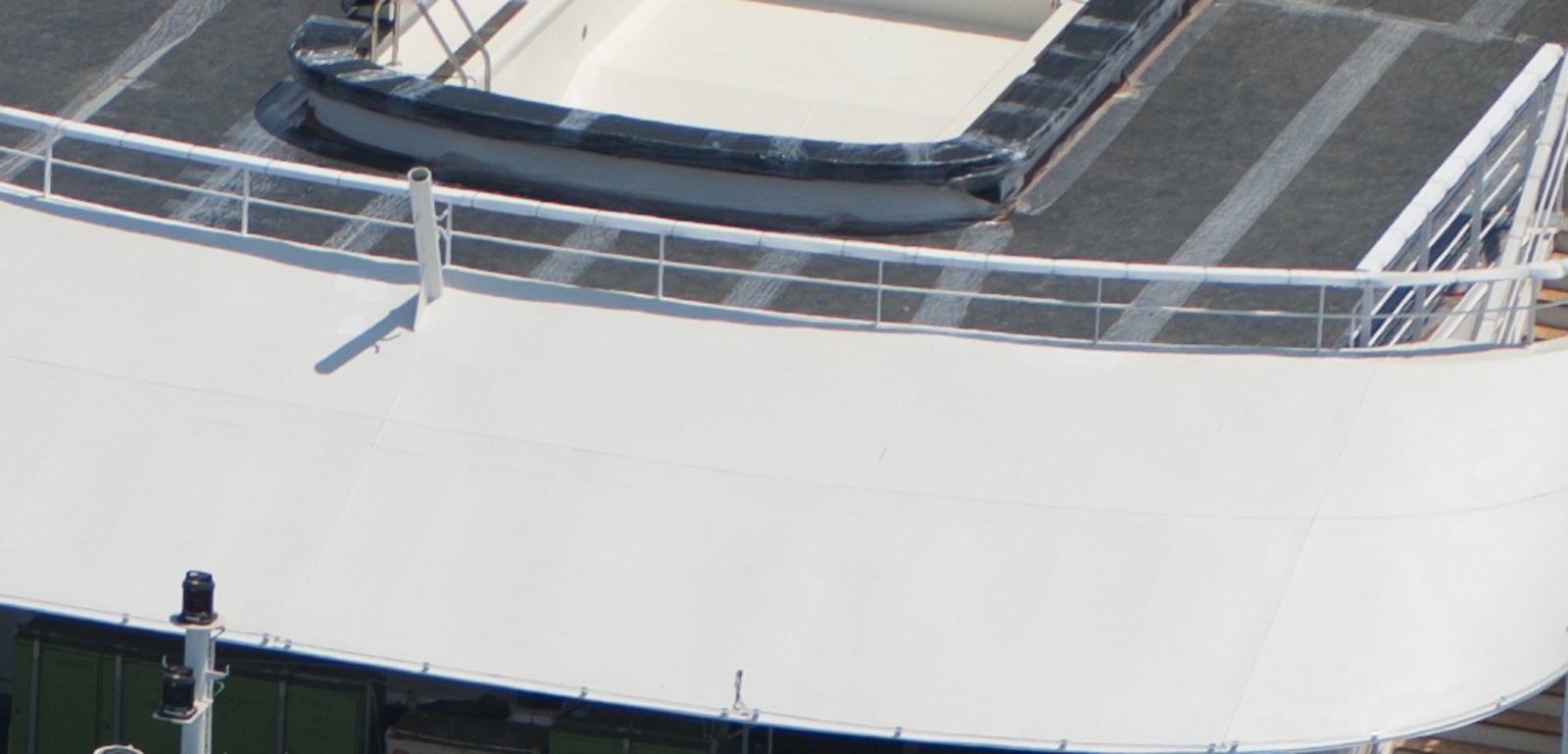  Fincantieri | Group - Business - Products - Cruise Ships - L'Austral: Rear view of luxury cruise ship L'Austral in operation sailing through deep blue waters, dynamic wake visible, sleek design and modern features, name 'L'Austral' clearly displayed on exterior.