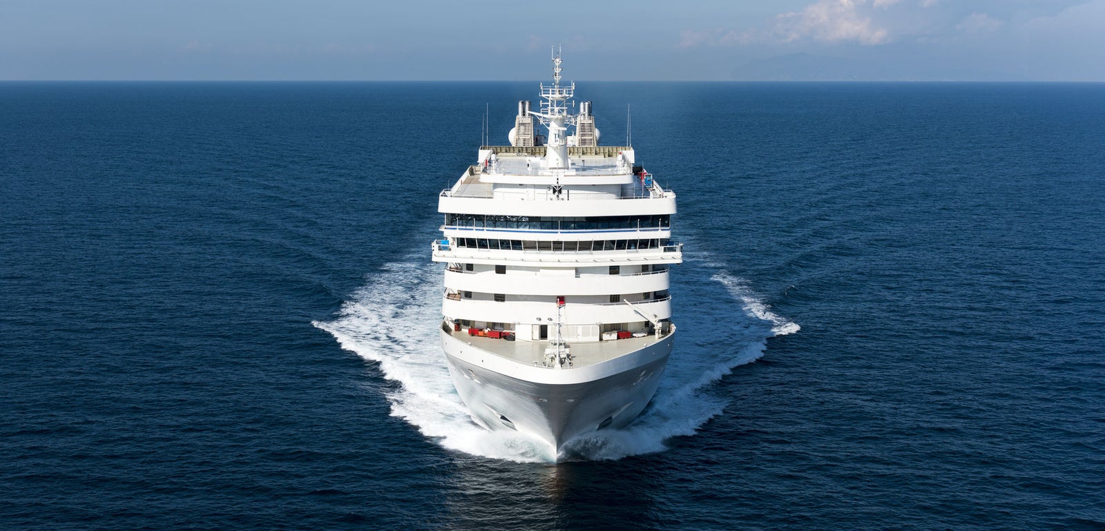 Fincantieri | Group - Business - Products - Cruise Ships - Silver Muse: Front view of Silver Muse cruise ship in operation, white hull, modern design, multiple passenger decks.