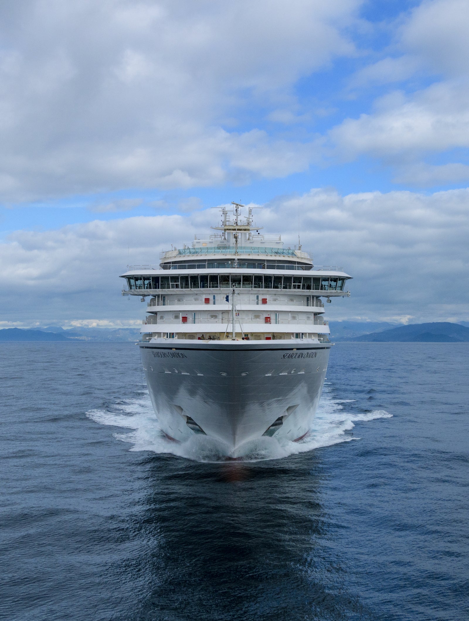 Fincantieri | Group - Business - Products - Cruise Ships - Seabourn Ovation: Side view of Seabourn Encore cruise ship in operation, white hull with modern design, Seabourn Encore name visible on side.