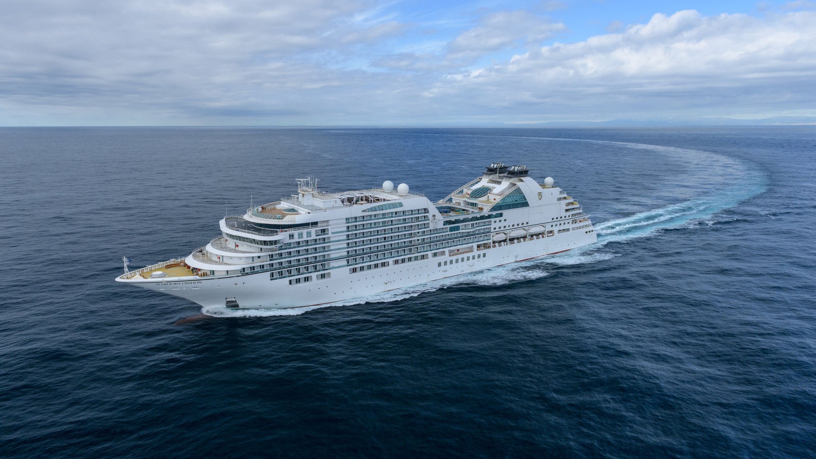 Fincantieri | Group - Business - Products - Cruise Ships - Seabourn Ovation: View of Seabourn Ovation expedition ship in operation, PC6 Polar Class modern hull design and multiple passenger decks.