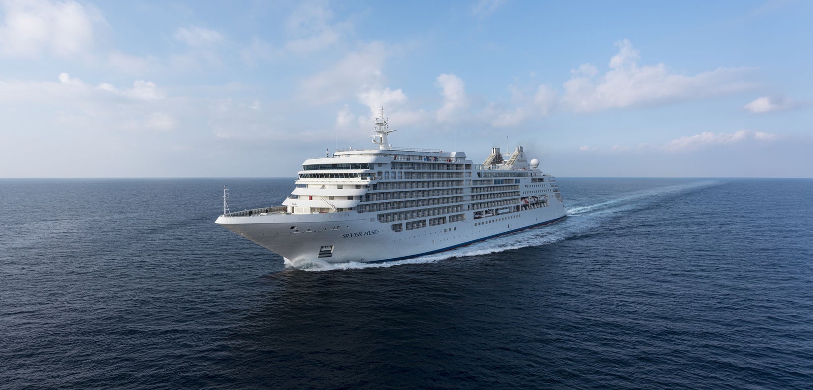 Fincantieri | Group - Business - Products - Cruise Ships - Silver Muse: Modern Fincantieri cruise ship in operation, multiple passenger decks, white hull with linear and elegant external design.