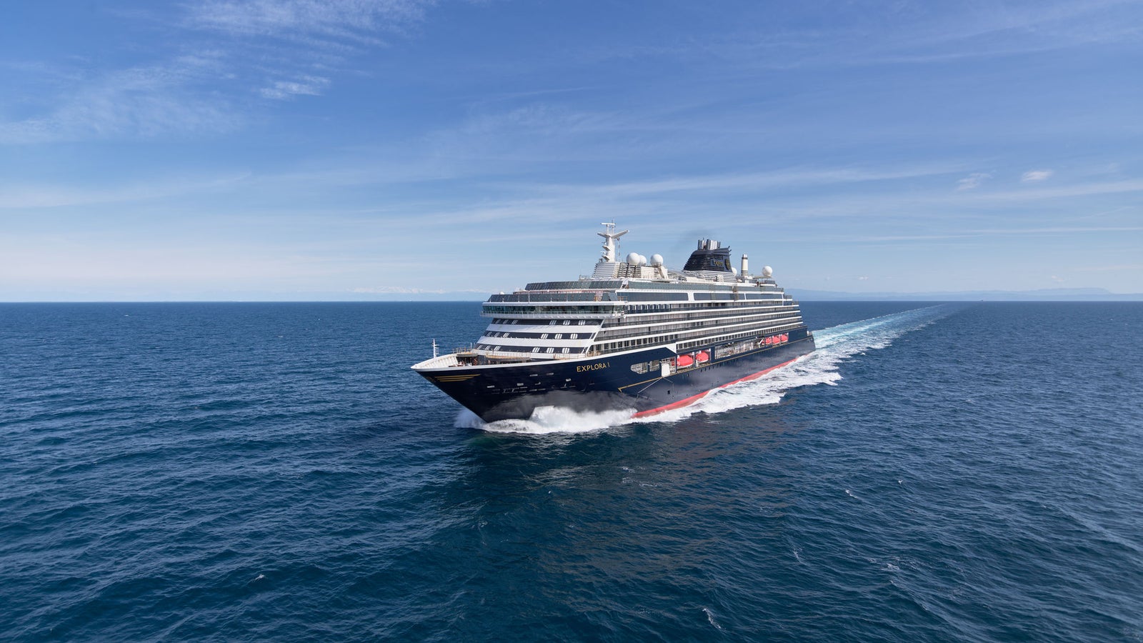 Fincantieri | Group - Business - Products - Cruise Ships - Explora I: View of luxury cruise ship in operation, modern hull design, passenger decks and visible outdoor areas.
