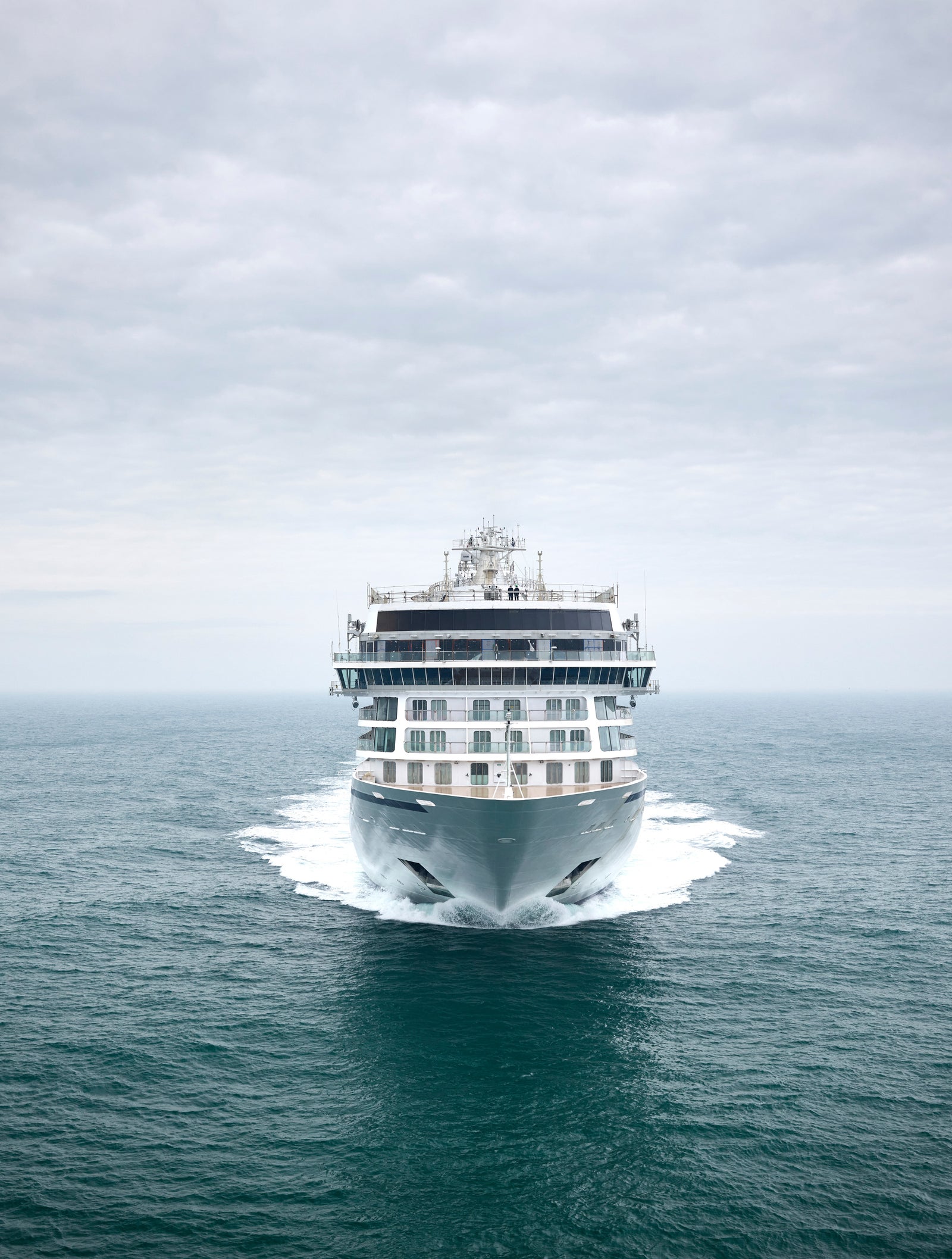 Fincantieri | Group - Business - Products - Cruise Ships - Viking Mars: Modern cruise ship in operation, centered frame, sailing through calm open waters under cloudy sky, sleek design and multiple decks, tranquil and expansive atmosphere.