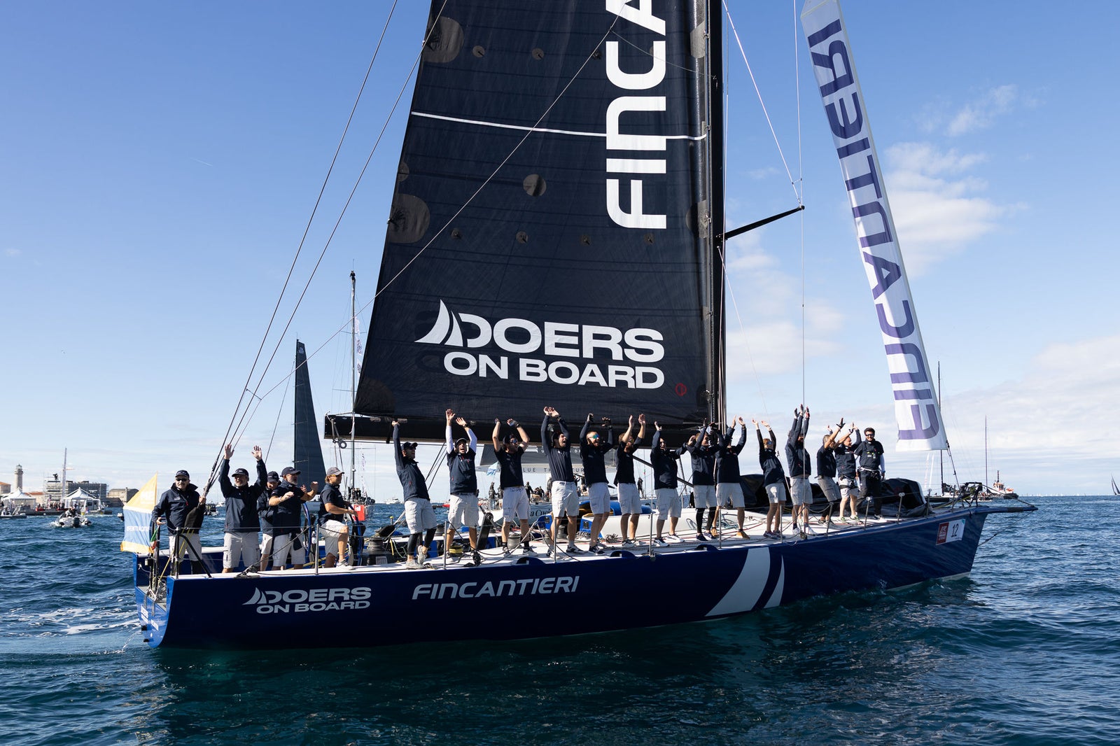 Sailing crew celebrates aboard racing yacht