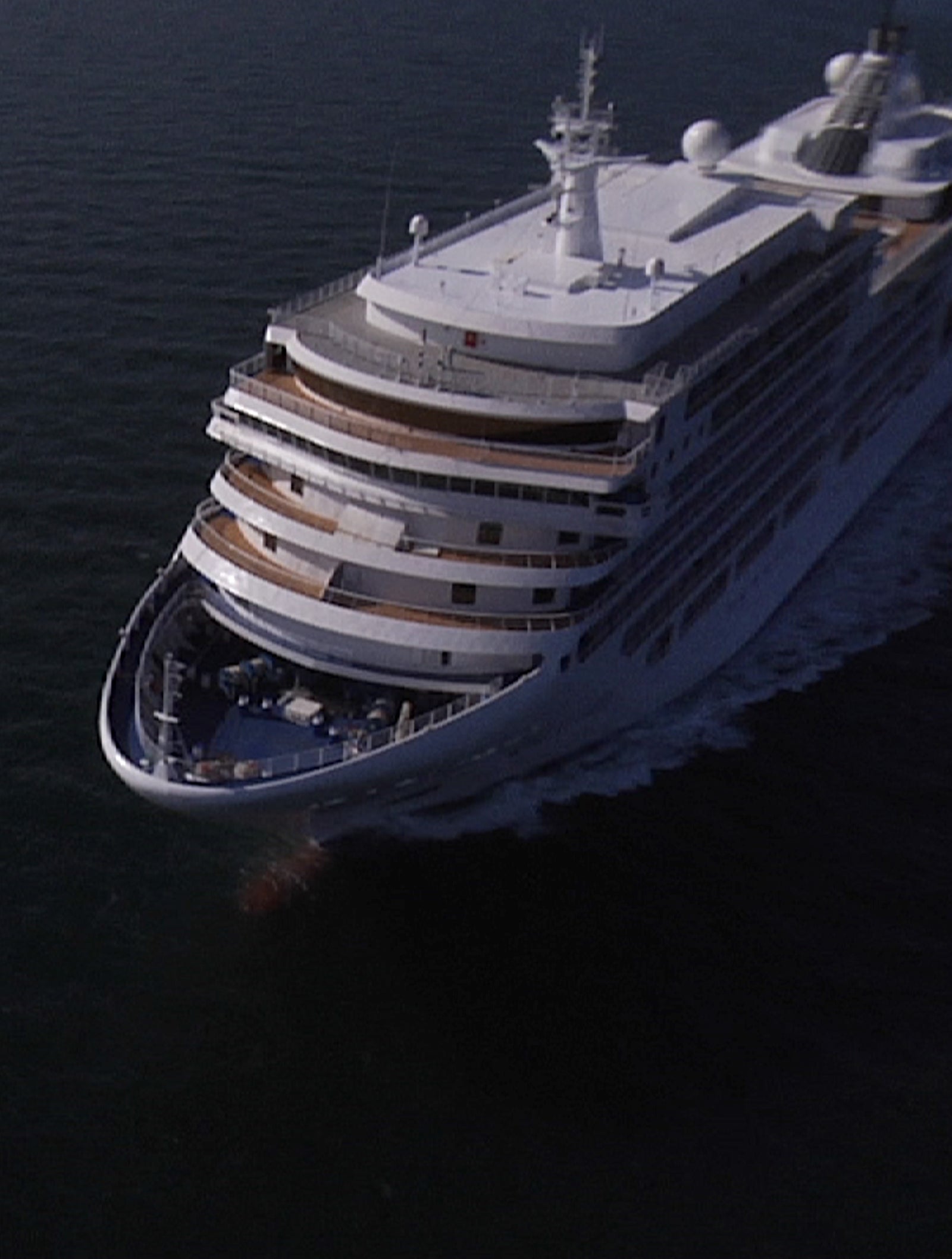 Fincantieri | Group - Business - Products - Cruise Ships - Silver Spirit: Imposing luxury cruise ship in operation gliding on calm waters under partly cloudy clear sky, many decks with balconies and visible lifeboats, scene evokes elegance and relaxation for an exclusive journey.