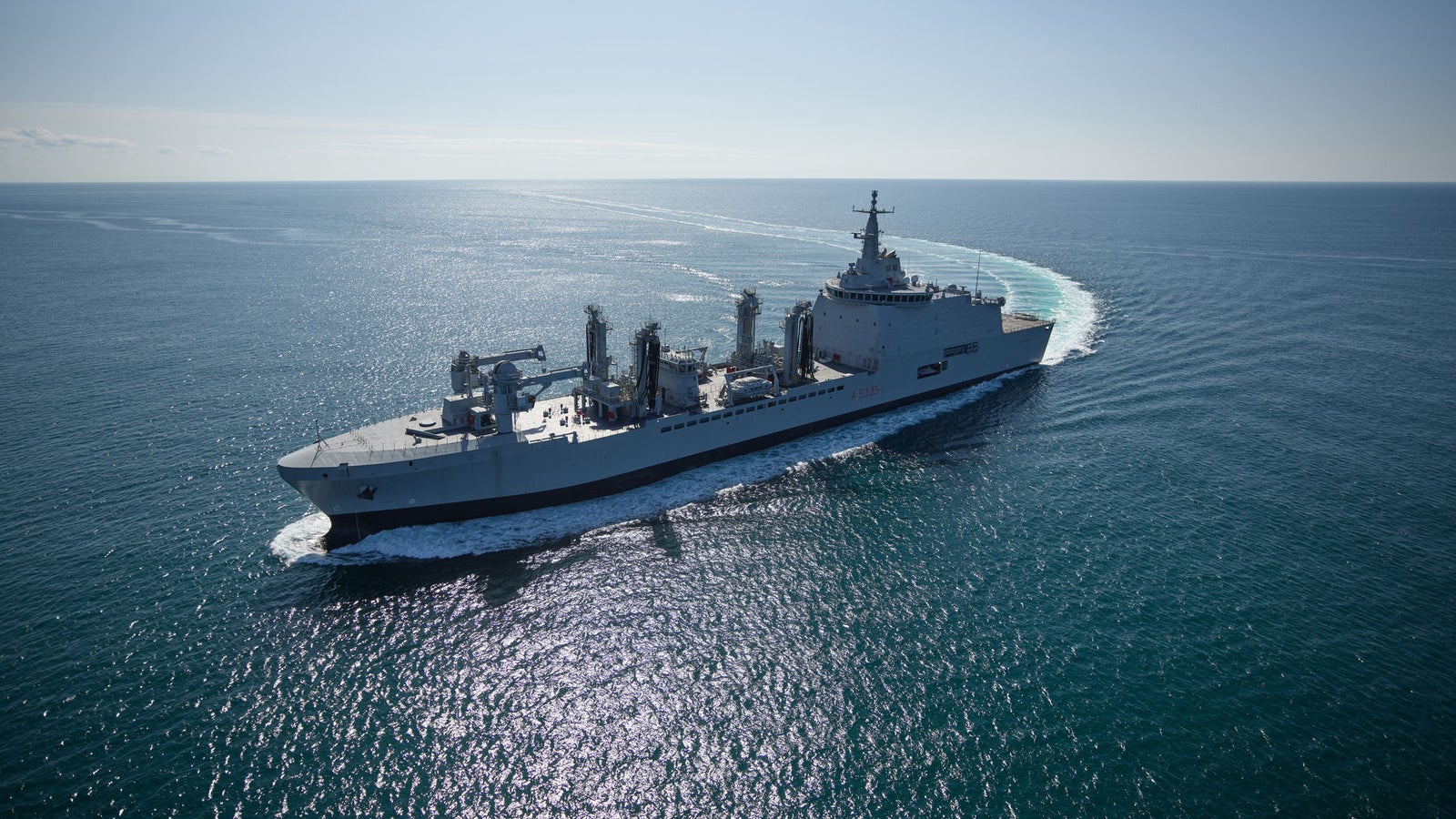  Fincantieri | Gruppo - Business - Prodotti - Navi Logistiche e di Rifornimento - Classe Vulcano: Vista laterale della nave operativa in navigazione, design slanciato, strutture di coperta e antenne visibili.