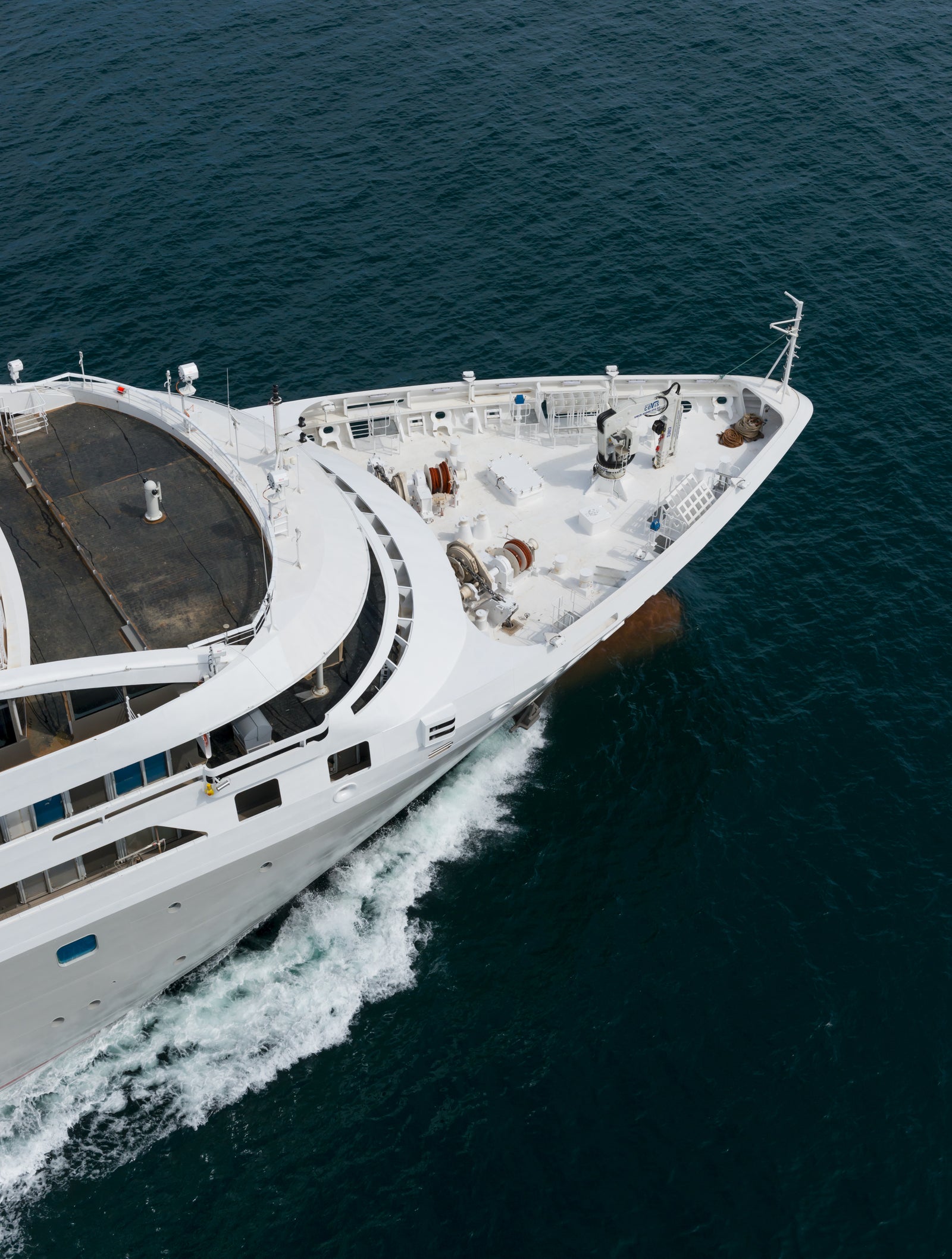 Fincantieri | Group - Business - Products - Cruise Ships - Le Soléal: Side view of Le Soléal cruise ship in operation navigating open sea, linear white hull, multiple passenger decks, clear sky.
