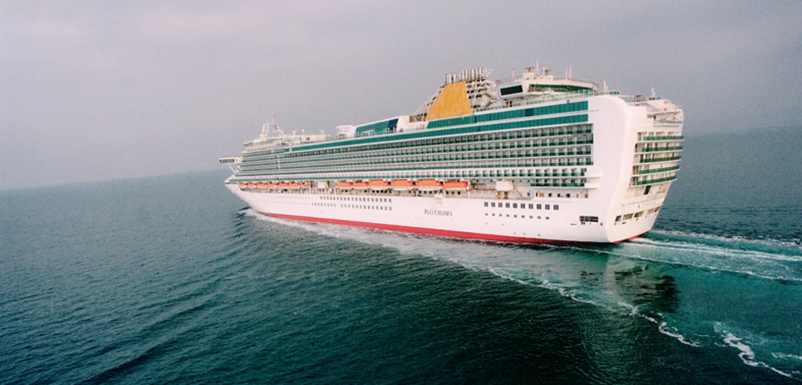 Fincantieri | Group - Business - Products - Cruise Ships - Ventura: View of Ventura cruise ship in operation navigating open sea, white hull with multiple passenger decks, visible lifeboats and ship name on hull.