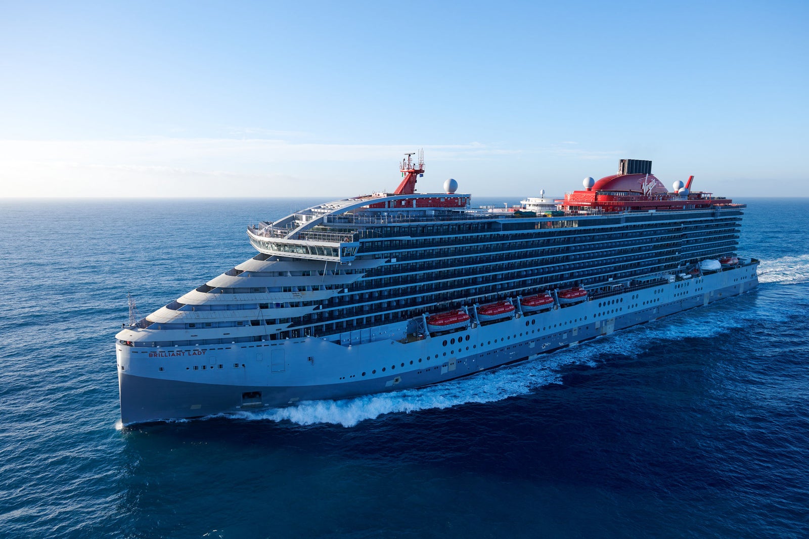newsroom - press releases - 2025 - fincantieri group: fincantieri agrees extension of the maturity of the loan granted to virgin cruises: virgin voyages cruise ship "brilliant lady" sailing in open sea, sunny sky and ship name visible on the bow.