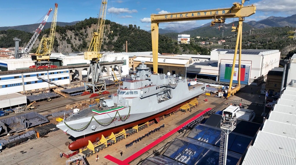 Newsroom - Press releases - 2026 - Fincantieri Group: launch of the first next-generation offshore patrol vessel for the Italian Navy: next-generation offshore patrol vessel with tricolor ribbon on slipway at fincantieri shipyard, surrounded by cranes and ceremony guests.