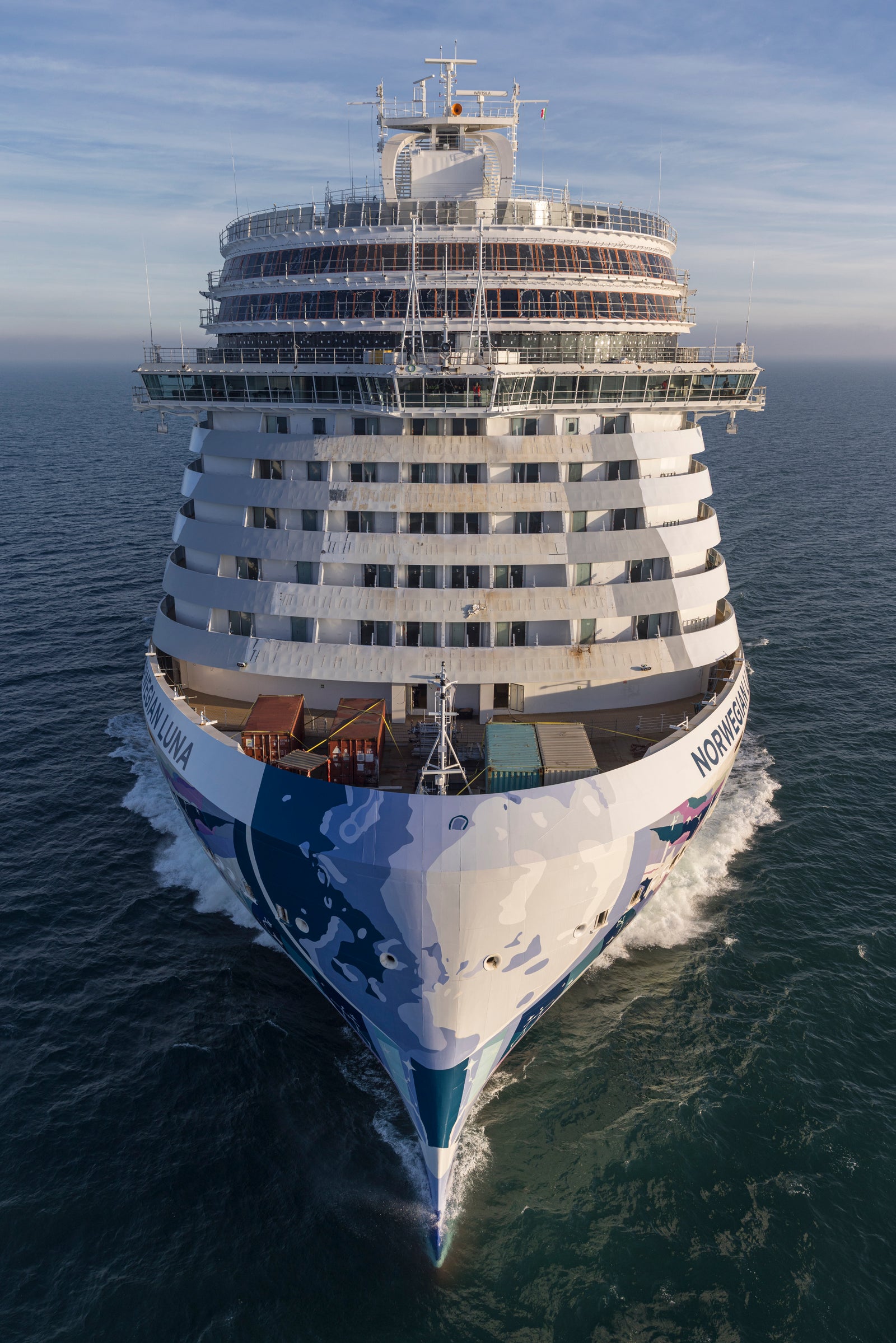 Fincantieri | Gruppo - Business - Prodotti - Navi da Crociera - Norwegian Luna: Bow of cruise ship Norwegian Aqua in open sea, multicolored rainbow livery.  Fincantieri | Gruppo - Business - Prodotti - Navi da Crociera - Norwegian Aqua: Prua della nave da crociera Norwegian Aqua in mare aperto, livrea multicolore arcobaleno.