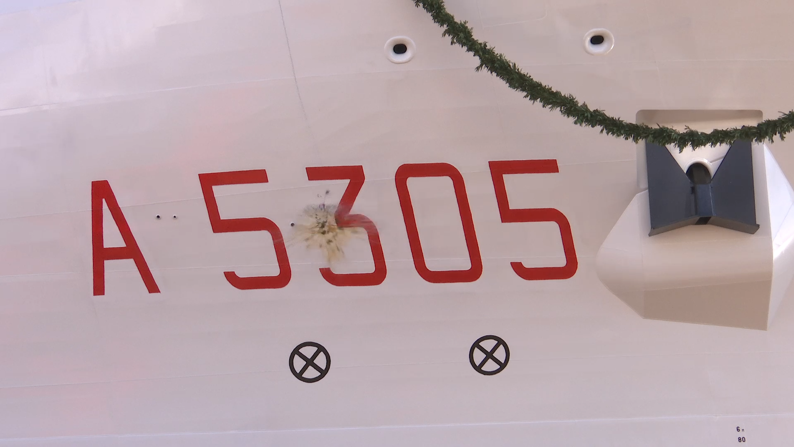 Newsroom - Press releases - 2026 - Fincantieri Group: Launch of the Italian Navy's "Quirinale" major hydro-oceanographic ship: champagne bottle smashes on hull of a5305 "quirinale" during launching ceremony, with red hull number.