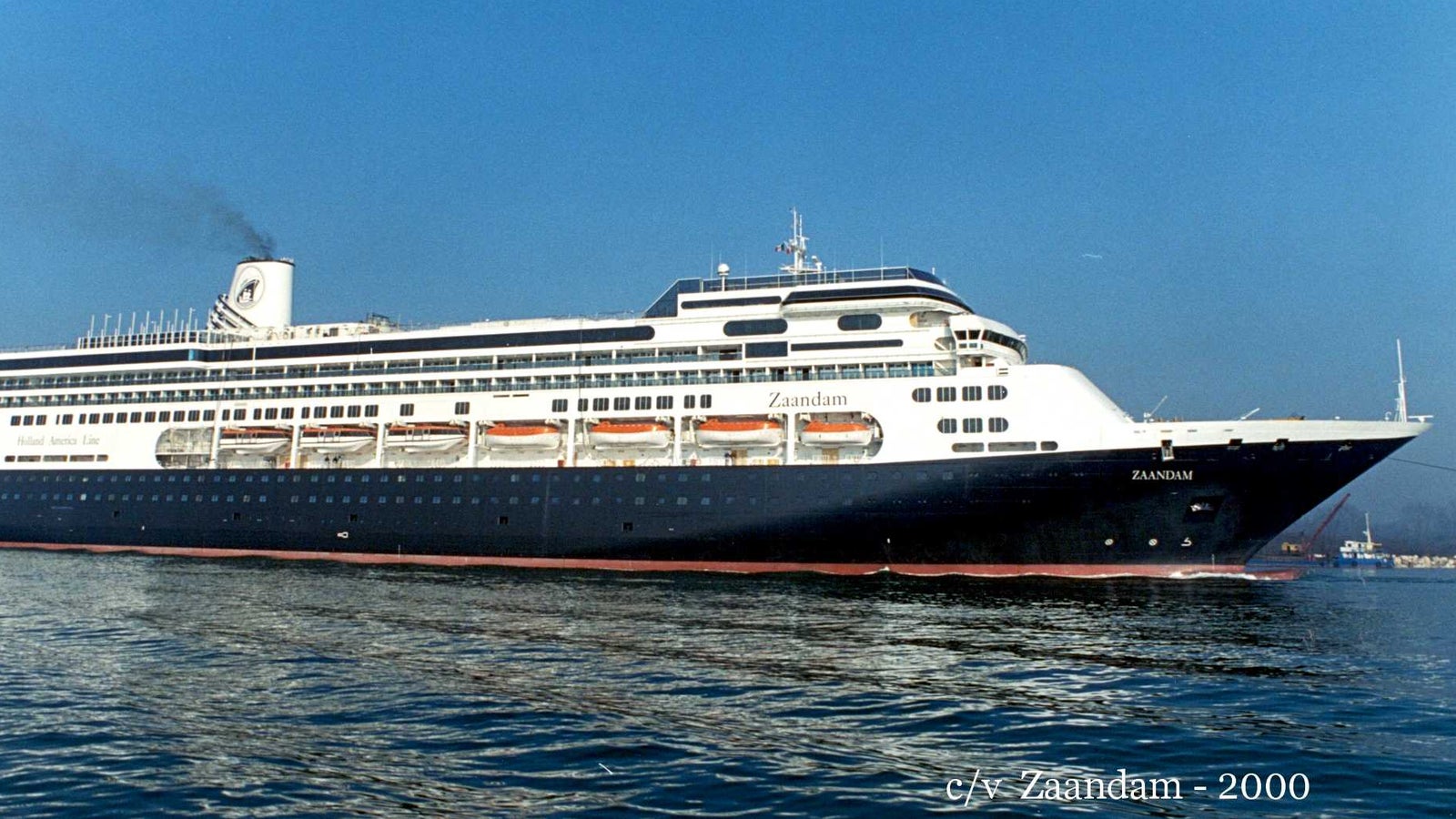 Fincantieri | Group - Business - Products - Cruise Ships - Zaandam: Side view of Zaandam cruise ship in operation, linear hull design, multiple passenger decks and visible lifeboats.